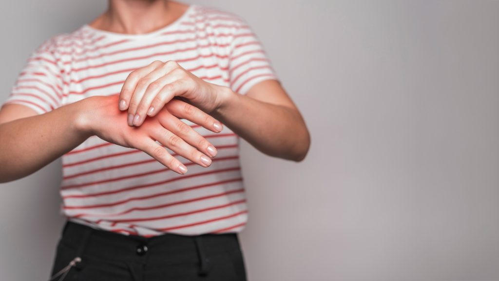Person holding a painful hand and wrist